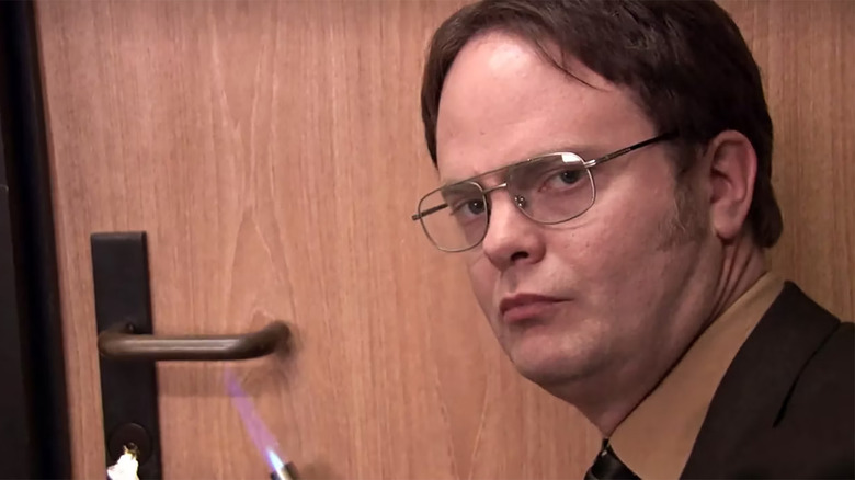 Dwight using a blow torch on a door handle in The Office
