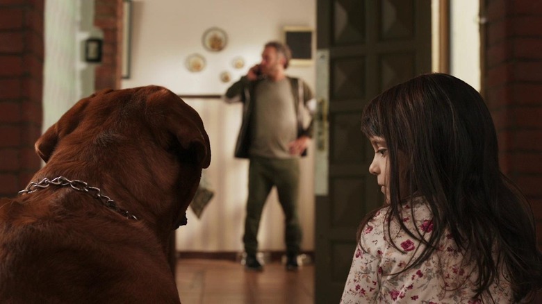 Vicky looks at the dog in When Evil Lurks