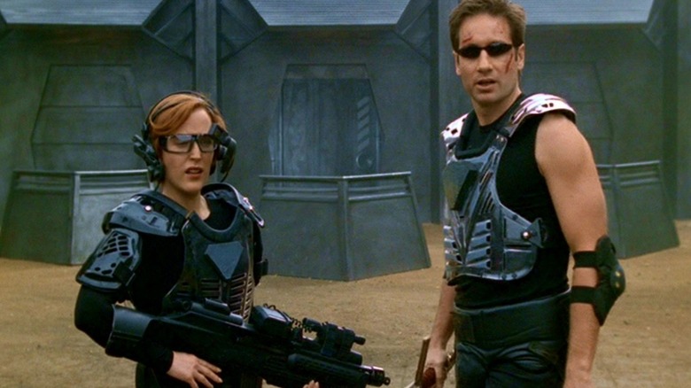 Scully and Mulder in silly-looking video game combat gear in an episode of The X-Files