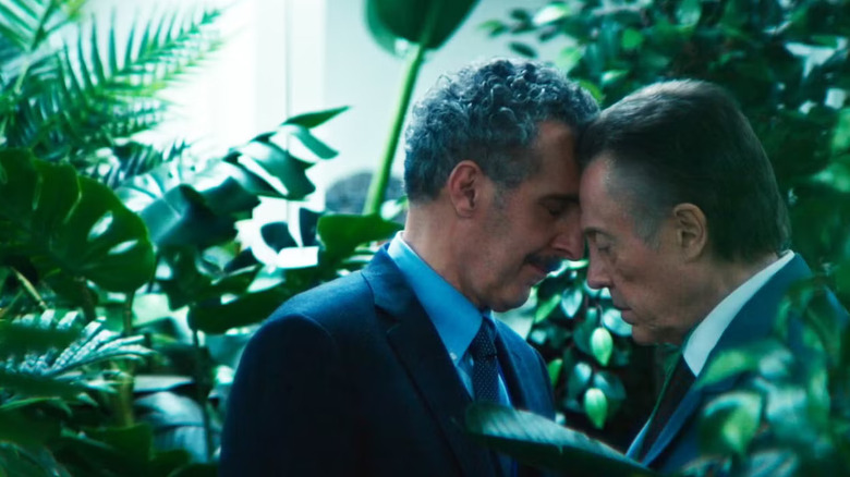 Burt and Irving surrounded by plants, leaning their foreheads together, on Severance