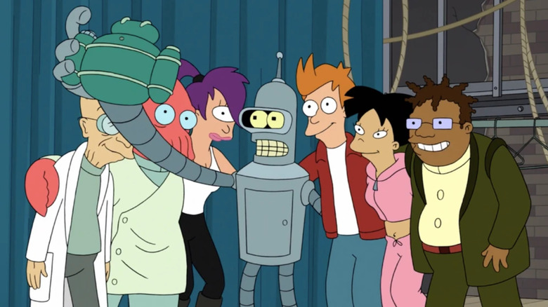 The Futurama characters lined up for a selfie, being snapped by Bender, holding the camera with an extended robotic arm.