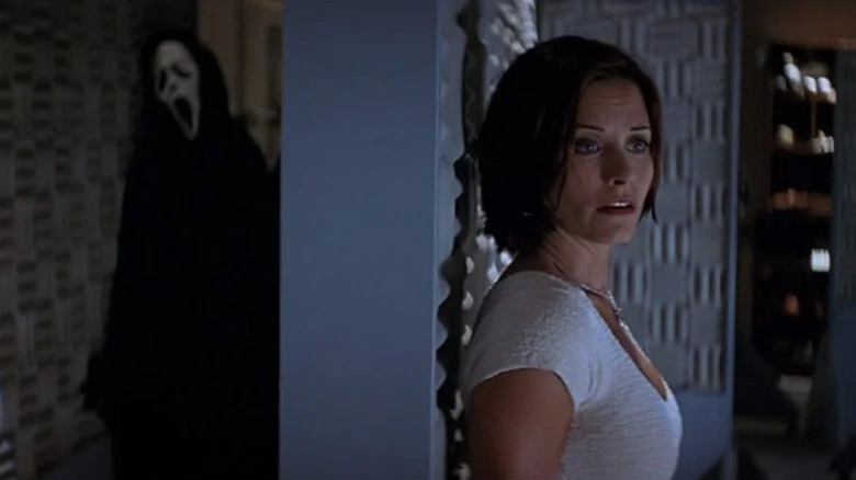 Courteney Cox's Gale Weathers hiding from Ghostface in Scream 2