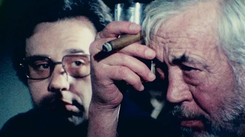 John Huston smokes cigar