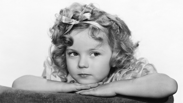 Shirley Temple resting head on hands