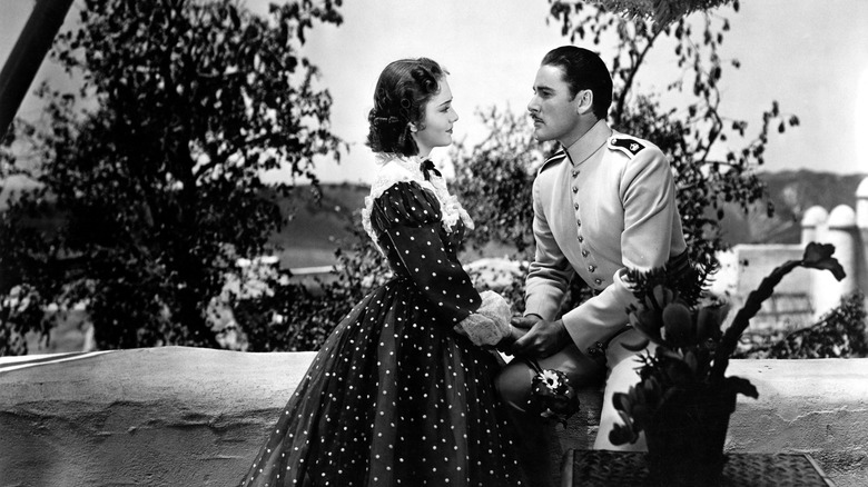 Geoffrey (Errol Flynn) and Elsa (Olivia de Havilland) hold hands in "The Charge of the Light Brigade"