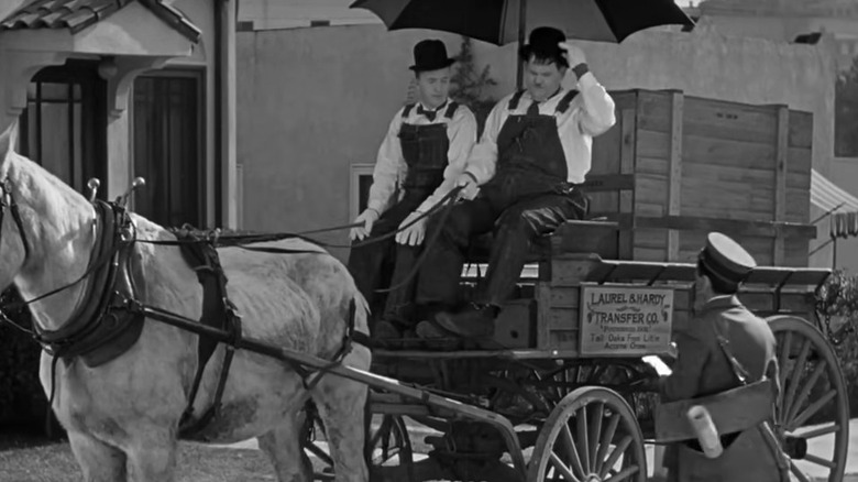 Stan Laurel and Oliver Hardy driving wagon in "The Music Box"