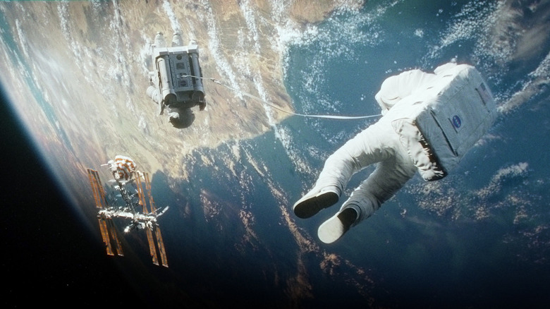 Astronaut floating outside space shuttle in "Gravity"