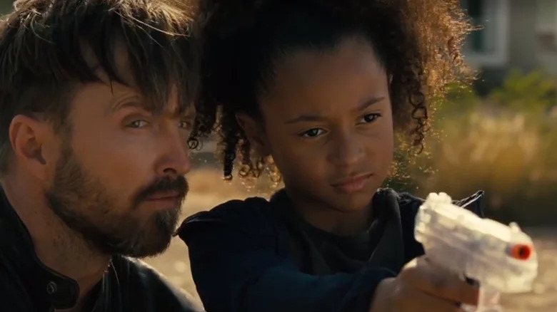 Caleb and his daughter practicing with a toy gun in Westworld