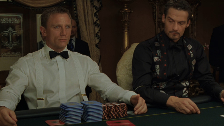 Casino Royale's Daniel Craig looking stern next to poker player