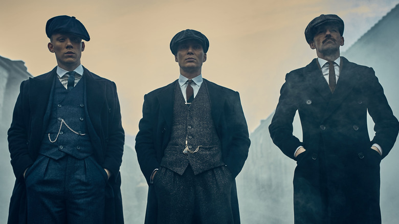 John Shelby, Tommy Shelby, and Arthur Shelby standing in fog in Peaky Blinders