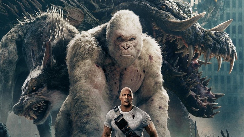 Dwayne Nsonson as Davis stands in front of the rampage poster (2018)