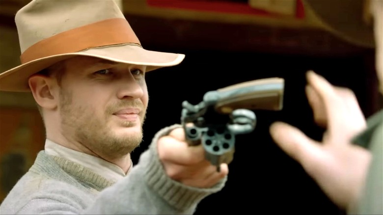 Tom Hardy passing a gun in "Lawless"