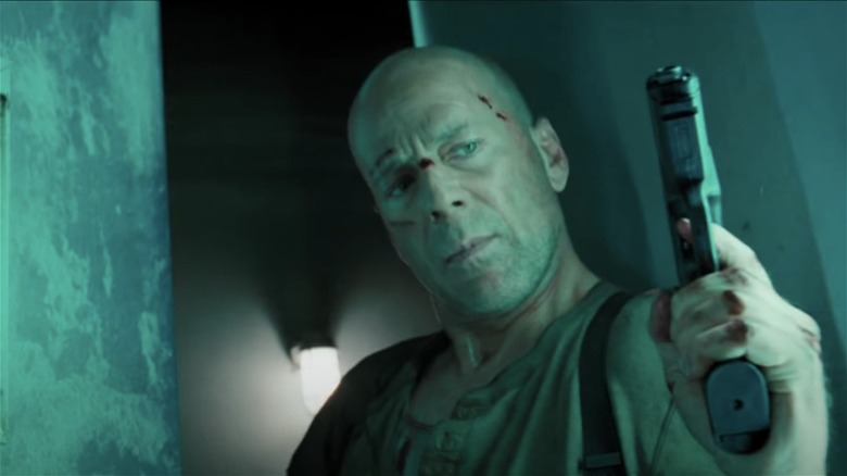 John McClane enters a room with a gun