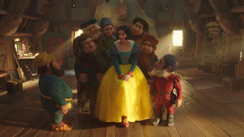 Snow White with the seven magic creatures in the hut in Snow White (2025)