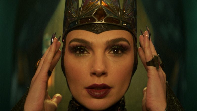 Gal Gadot as the Evil Queen staring at her reflection in Snow White (2025)