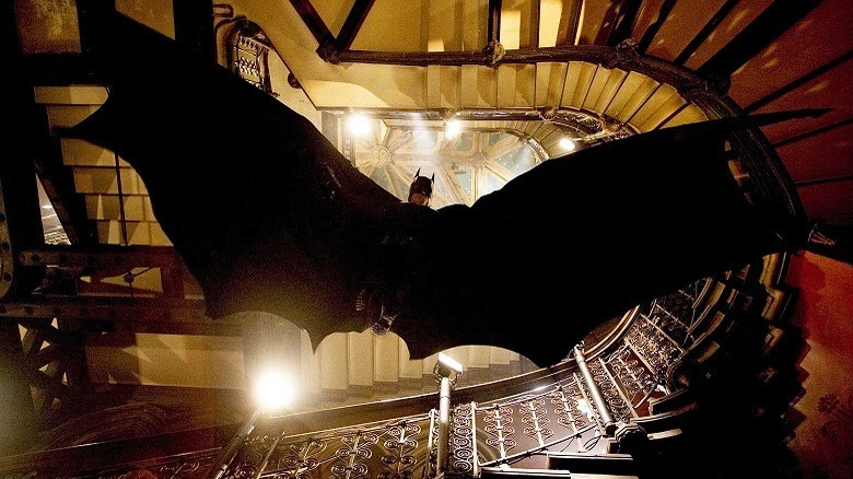 Batman descends down a staircase
