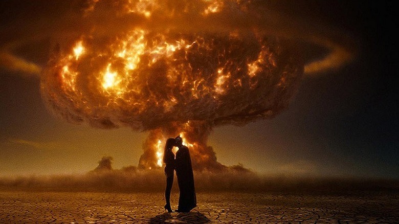 Nite owl and Silk Spectre embrace in front of a nuclear explosion