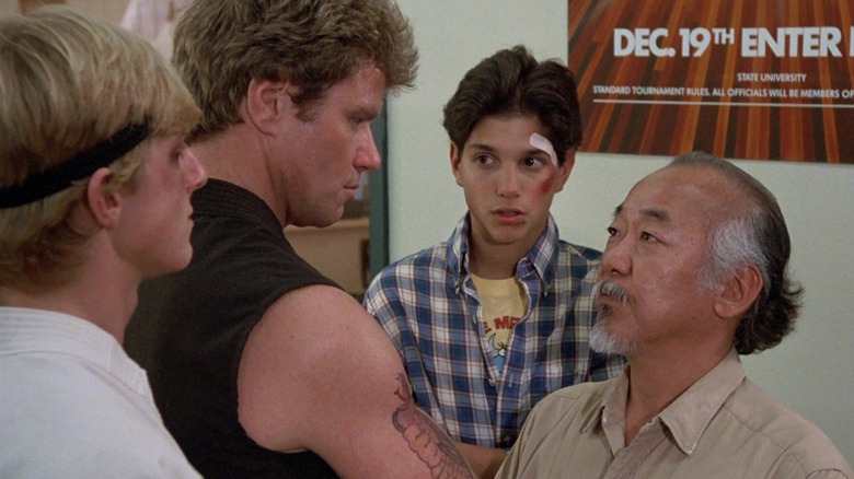 William Zabka, Martin Kove, Ralph Macchio, and Pat Morita in Karate Kid (fancaps shot)