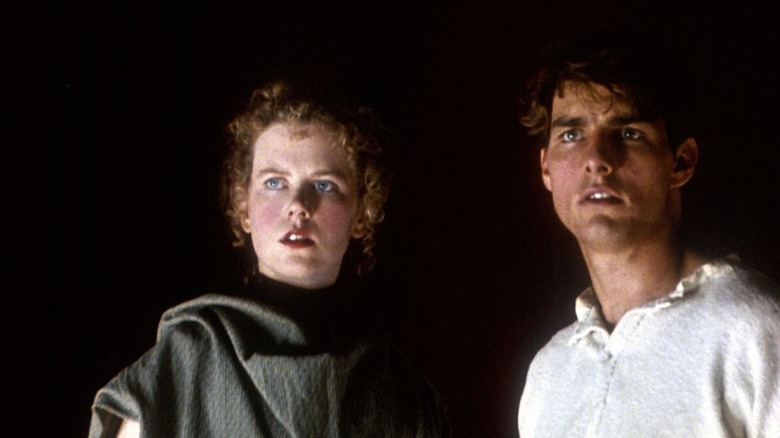 Nicole Kidman and Tom Cruise stand in the dark