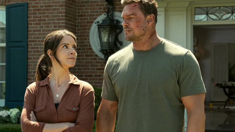 Alan Ritchson's Jack Reacher stands beside Sonya Cassidy's Susan Duffy in Reacher