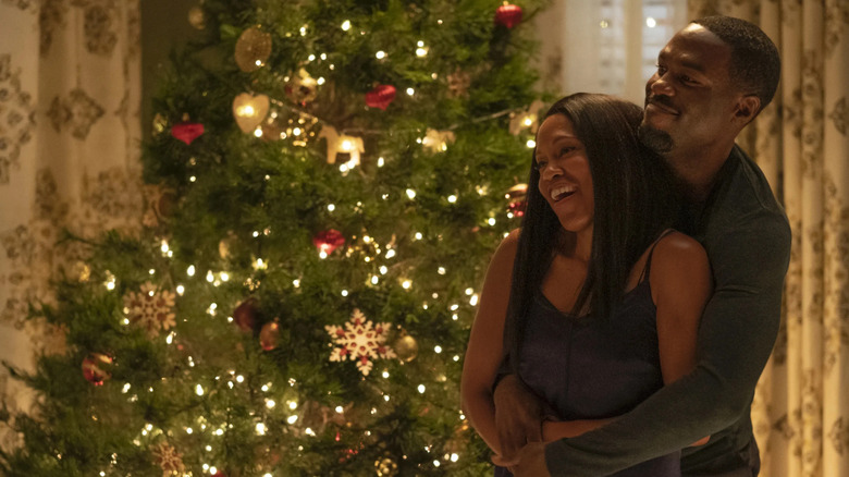 Angela and Cal stand by a Christmas tree in Watchmen