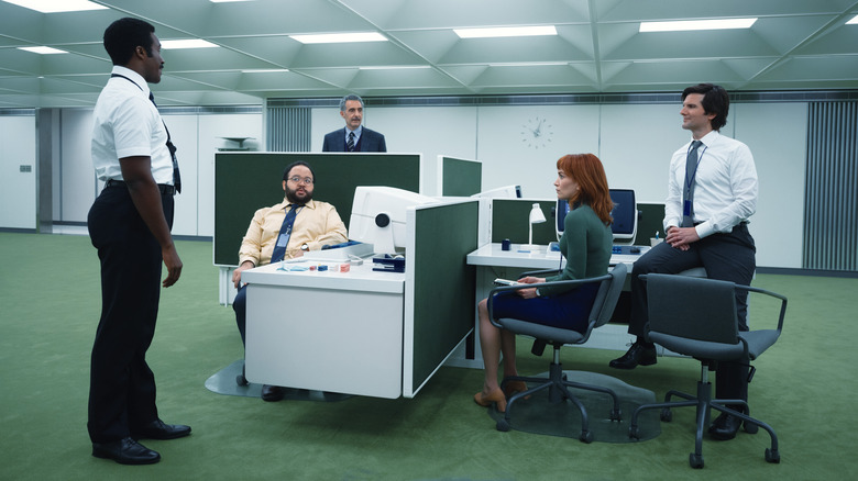 The cast of Severance sit in the Lumon offices in Severance season 1