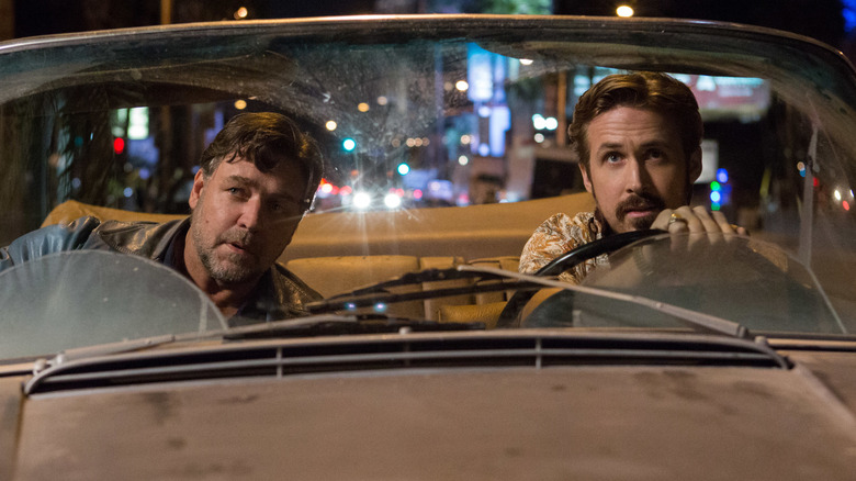 Russell Crowe as Jackson Healy and Ryan Gosling as Holland March riding in a convertible in The Nice Guys