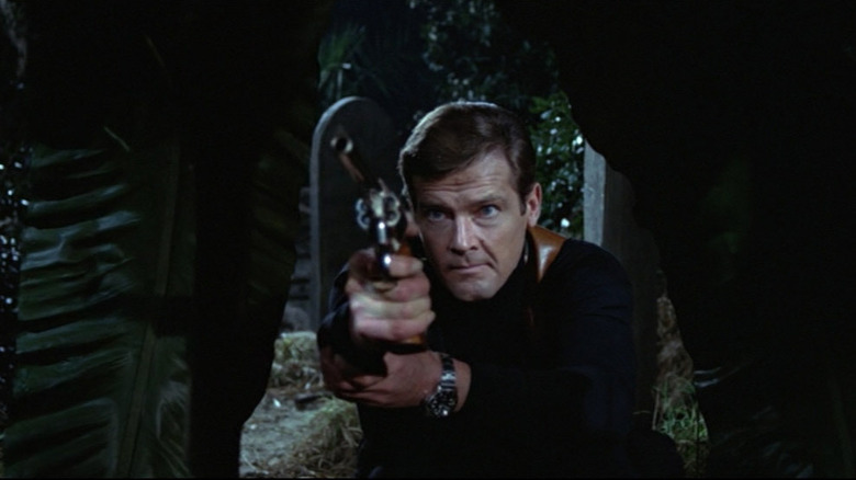 Roger Moore pointing gun