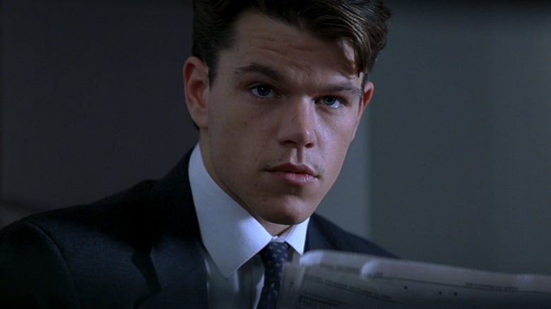 Matt Damon as Rudy looking up from a paper in The Rainmaker