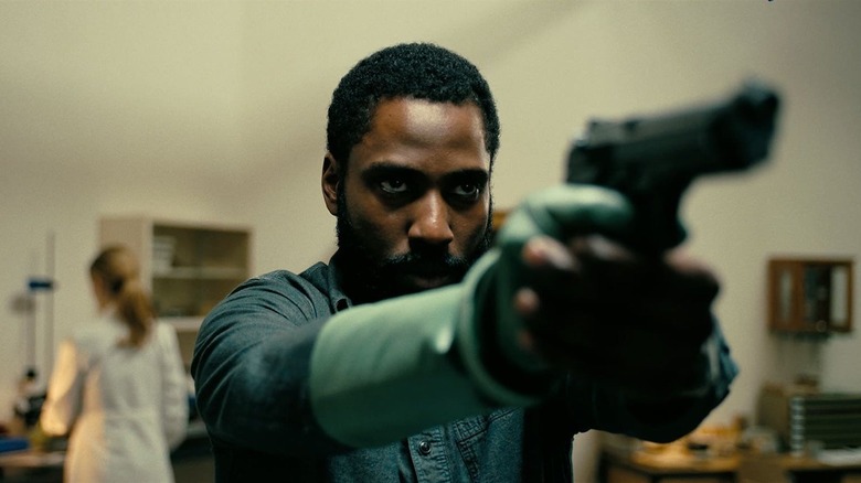 John David Washington brandishing a gun as the title character in Tenet