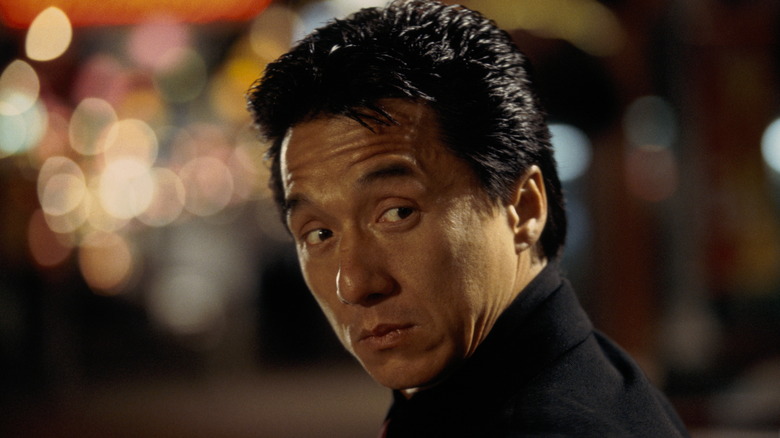 Jackie Chan as Chief Inspector Lee turning his head outside on the street in Rush Hour