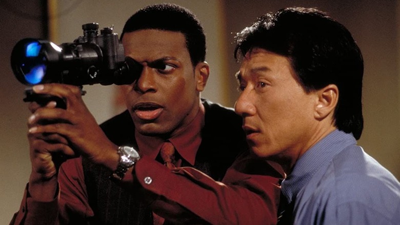 Detective Carter looks through a camera with Chief Inspector Lee standing next to him