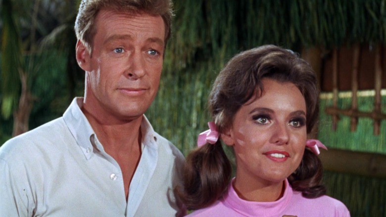 The Professor and Mary Ann standing next to each other, looking friendly on Gilligan's Island