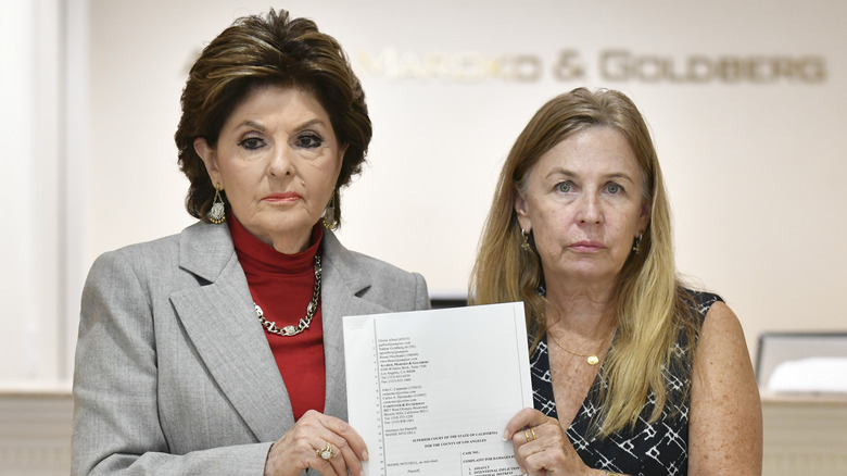 Attorney Gloria Allred holds a lawsuit filing with "Rust" script supervisor Mamie Mitchell