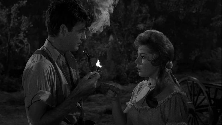 James Best as Jeff Myrtlebank lights his pipe in front of a startled Sherry Jackson as Comfort Gatewood in The Twilight Zone episode The Last Rites of Jeff Myrtleban