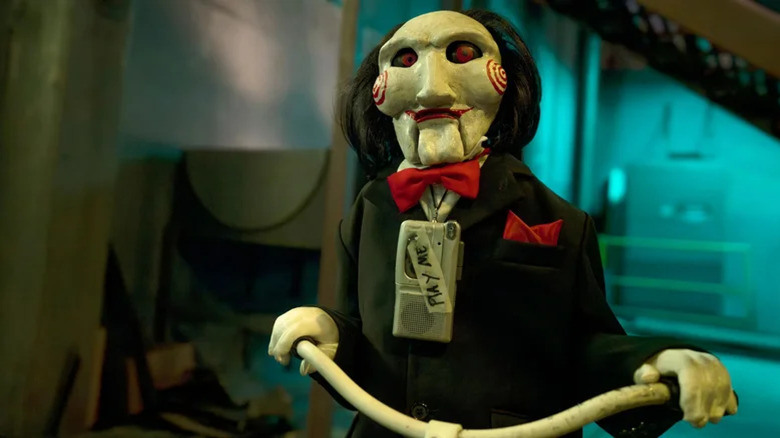 Billy the puppet riding his tricycle in Saw