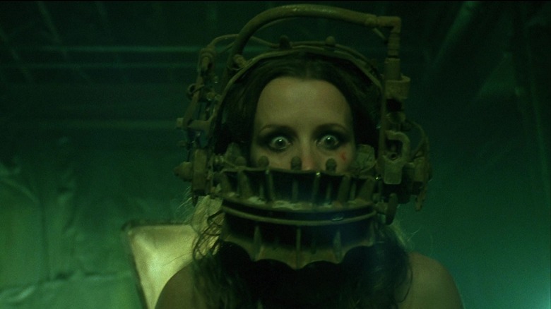 Amanda wearing the reverse bear trap from Saw