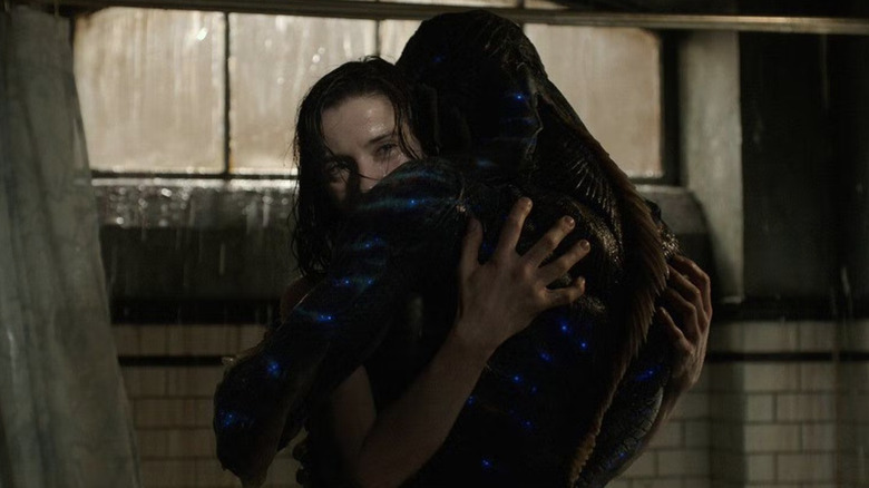 The Amphibian Man and Elisa embracing in "The Shape of Water"