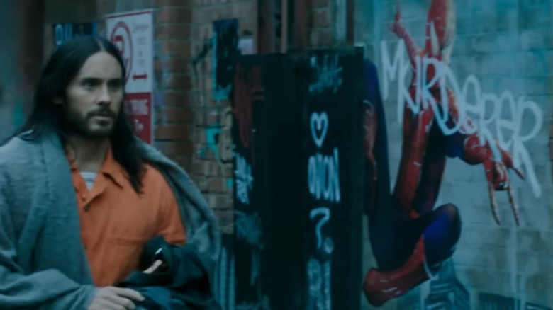 Morbius (Jared Leto) walking by Spider-Man mural in Morbius trailer