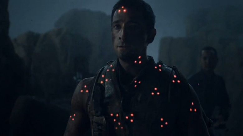 Royce (Adrien Brody) covered in laser sights in Predators