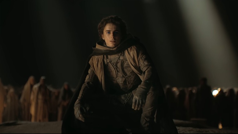 Paul Atreides crouching in front of a crowd