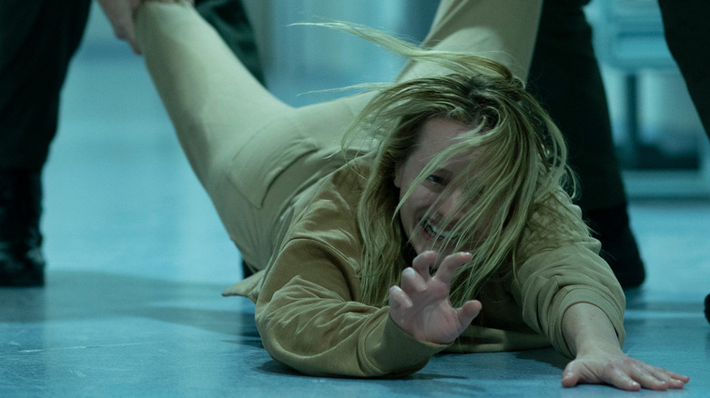 Elisabeth Moss being dragged away