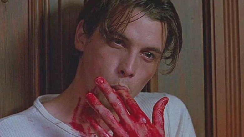 Billy licking fake blood fingers