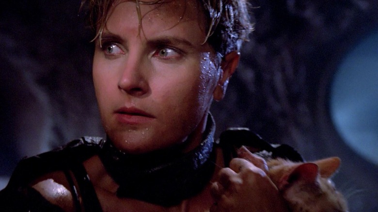 Tasha Yar, coated in sweat, holding a cat. She is terrified in Star Trek: The Next Generation