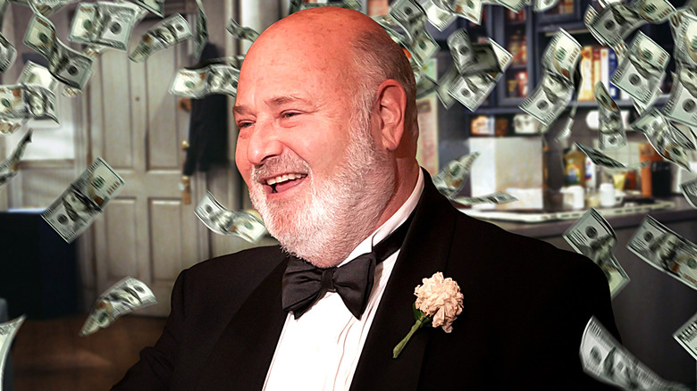 A composite image of Rob Reiner surrounded by piles of money superimposed at Seinfeld's Seinfeld apartment