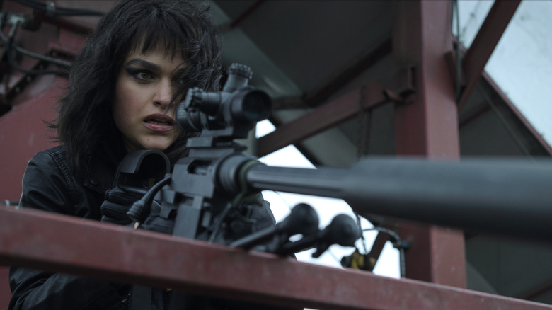 The Night Agent Eve Harlow as Ellen holding sniper rifle