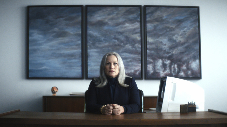 Patricia Arquette's Ms. Cobel sitting at a desk and scowling on Severance