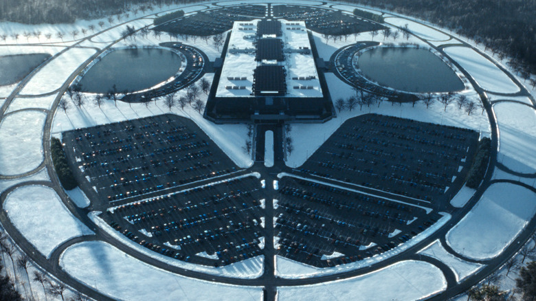 An overhead, birds-eye view of the main Lumon Industries building and surrounding area covered in snow in Severance