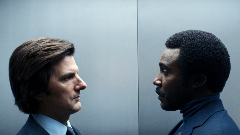 Mark and Milchick standing face to face in an elevator on Severance