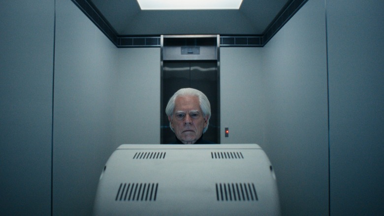 Michael Siberry as Jame Eagan sitting behind a computer in a small room in Severance